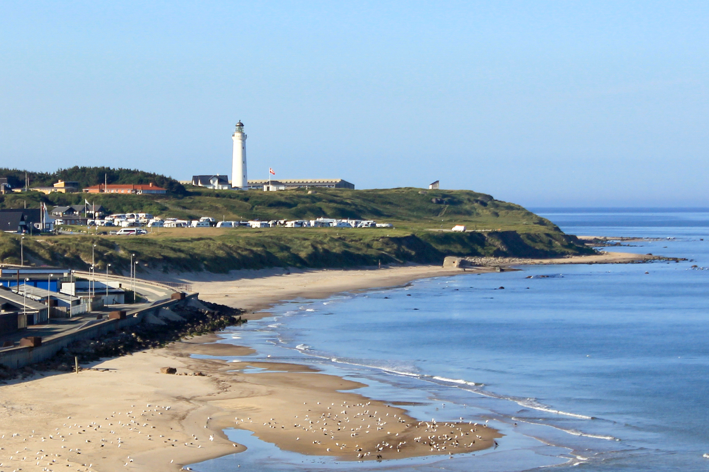 Hirtshals lighthouse above the sandy beach on Denmark's North Sea coast. The Norröna departs for the Faroe Islands from here.